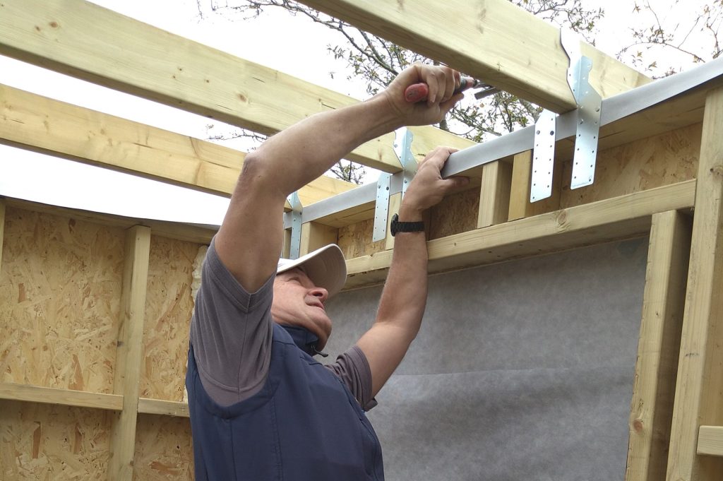 Firwood Garden Room St Albans – Interior (Worker Installing Beams Inside The Structure).