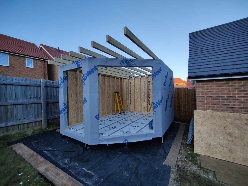 The Mallard Garden Room In St Albans - External Finish (Wooden Framework With Insulation Wrapping And Roof Beams In Place During Construction)